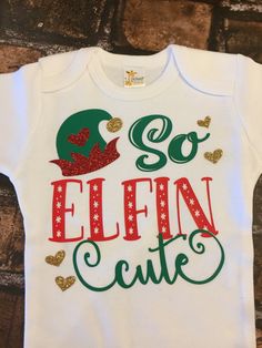 "Our Custom made \"So Elfin Cute\"is perfect for Baby's Christmas Photos or Christmas dinner. We pair our outfit with red and green chevron legwarmers accented with a bow, a red and green chiffon tutu bloomer (looks like a skirt), and a matching headband. Visit all of our Christmas outfits here: https://www.etsy.com/your/shops/PrincessKeepsakes/tools/listings/section:21517506 Each bodysuit/shirt is handmade after your order is placed. Your items will be immediately shipped after completion and y Cute Christmas Holiday Onesie, Cute Christmas Onesie, Newborn Christmas Outfit, Baby Christmas Photos, Outfit Holiday, Bodysuit Shirt, Girls Christmas Outfits, Cute Newborn, Newborn Christmas