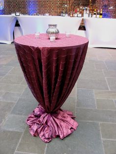 a round table with a purple cloth on it