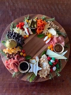 a wooden plate topped with lots of different types of food on top of a table