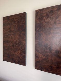 two pieces of wood are hanging on the wall