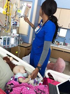 a woman in a hospital bed with a baby laying on it's side and an iv machine hooked up to her arm