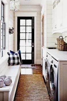 a laundry room with a washer and dryer next to a door that leads into the kitchen