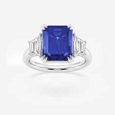 Get lost in the mesmerizing facets of this emerald cut three stone ring, featuring a striking blue sapphire thats sure to turn heads. The emerald cu Emerald Three Stone Ring, Emerald Cut Sapphire Ring, Sapphire Rings, Emerald Engagement Ring Cut, Three Stone Ring, Engagement Rings Platinum, Ring Ideas, Three Stone Engagement, Three Stone Engagement Rings