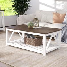 a living room with a white couch and coffee table