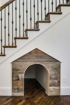 an empty dog house under the stairs