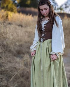 17'th century peasant-style dress. Made of 100% natural linen and cotton voile, this dress is a beautiful depiction of a typical working-woman's gown from the 1600-1700's. Bodice is lightly boned and made to fit snugly over the loose, full-sleeved blouse. The matching skirt fastens with a hook and eye closure and zipper in the back. Please note that the white fabric used will be slightly different than what the blouse is made of in the picture. Matching bodice and skirt sold in a separate listing: IMPORTANT! PLEASE NOTE WHEN CHOOSING A SIZE: Follow the diagram and chart when choosing your size. Make sure to measure around the widest part of your bust, your natural waist, around your arm at the socket, and your height from your natural waist to your ankle. Enter those measurements in the pe 1800s Peasant Dress, Peasant Dress Aesthetic, 1700s Dresses Peasant, 17th Century Dress Peasant, Medieval Clothing Women Peasant, Cotton Dresses For Larp, Medieval Cotton Fitted Dress, Medieval Style Fitted Cotton Dress, Cotton Peasant Prairie Dress