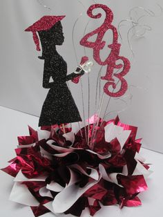 a red and black centerpiece with a woman holding an umbrella on top of it