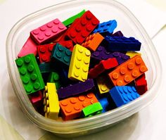 a plastic container filled with legos on top of a table