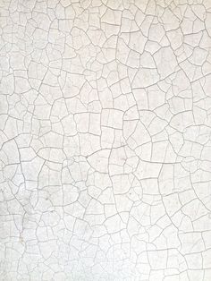 a white tile with cracks in it