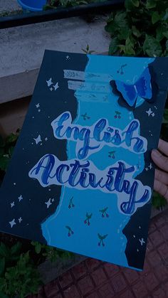 a person holding up a sign that says english activity