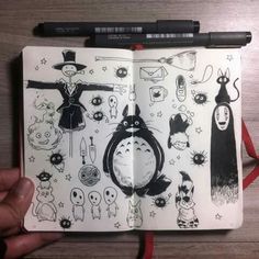 an open notebook with drawings on it