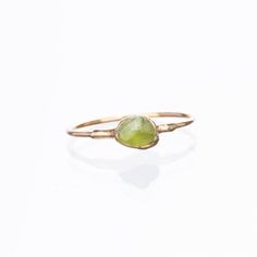 A minimal peridot  ring with a petite 14k gold filled shank. These  tumbled peridots are genuine and natural, and complemented with a textured setting on either end. This ring stacks well with other raw crystal rings. This ring has been dipped in genuine 24k gold. A lovely gift for August babies as peridot is the birthstone for August. ✨14k Gold Filled Shank24k Gold Dipped for deeper color. Genuine Peridot, 3.5-5mm✨Please read our FAQ for more information on our unique materials and process. You Dainty Peridot Birthstone Ring As Gift, Dainty Peridot Birthstone Ring For Gift, Gold Stackable Rings With Peridot Birthstone, Dainty Green Peridot Rings, Green Peridot Birthstone Ring, Dainty Style, Stackable Yellow Gold Peridot Jewelry, Gold Peridot Stackable Rings As Gift, Gold Stackable Peridot Rings As A Gift, Gold Peridot Birthstone Ring For May