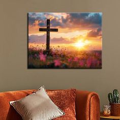 a living room with a couch and a cross on the wall in front of it