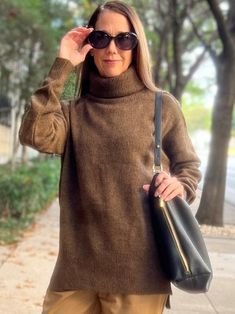 Oversized brown turtleneck sweater. The model is wearing it with tan pants, a black leather tote bag, and black sunglasses. She is posing in front of trees on a sidewalk. Oversize Turtleneck Sweater, Oversize Turtleneck, Oversized Turtleneck Sweater, Oversized Turtleneck, Casual Friday, Sell On Amazon, Brown Sweater, Girls Sweaters, Turtleneck Sweater