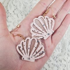 "Dainty and adorable, these soft and flexible Seashell Faux Leather Textured Earrings are the perfect little gift for most occasions such as:  A simple gift for her, Christmas, Birthdays, Anniversary's, Valentine's Day, gifts and many more! Each leaf is cut on soft flexible rose gold and pink with silver speckles textured faux leather with a soft felt-like light white fabric on the back, and are hanging on surgical steel earring hooks with transparent earring backers. Featured are also swarovski crystal rhinestones which really give these earrings that extra glitter and sparkle you need to light up the room! SIZING: Seashell cutouts are approximately 1.5\" X 1.5\" Overall approximate length of earring when worn is 2.25\" If you are interested in a different color, please reach out prior to Textured Earrings, Speckled Texture, Simple Gift, Bridesmaid Gifts Jewelry, Surgical Steel Earrings, Gold And Pink, Jewelry Birthday, Birthday Jewelry Gift, Simple Gifts