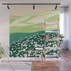 a wall mural with white flowers and green hills in the background