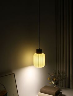 a lamp that is sitting on top of a table next to a vase with flowers