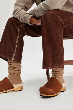 Slip into pure coziness with these sherpa-lined clogs, featuring classic suede uppers and an oak wood sole, complete with stud details for a subtle touch of shine. **Features:** Slip-on style, backless design, round toe, suede uppers, sherpa lining and footbed, oak wood sole, stud accents, rubber outsole **Why We | Oak Cozy Clog Mules by FP Collection at Free People in Tan, Size: US 8 Winter Suede Clogs With Rubber Sole, Comfortable Winter Clogs With Leather Sole, Winter Clogs With Suede Lining And Comfortable Style, Winter Suede Slip-on Clogs, Comfortable Shearling Clogs With Rubber Sole, Winter Comfortable Clogs With Suede Lining, Winter Clogs With Suede Lining, Cozy Winter Clogs With Rubber Sole, Winter Slip-on Suede Clogs