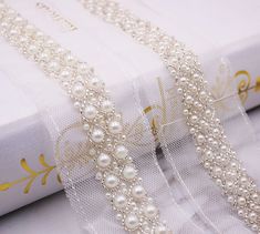 white pearls and crystal beaded trimmings on a book with gold foiling