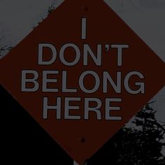 a red sign that says i don't belong here