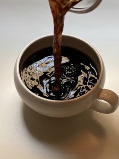 a cup filled with liquid sitting on top of a table