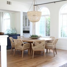 the dining room table is surrounded by wicker chairs