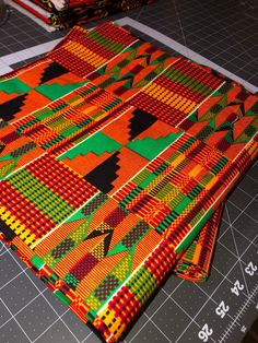 Ankara Fabric 100% cotton, Double-sided Material: 100% Cotton Width: 46"" The vibrancy and intensity of this piece is real, highly potent.  The colors just pop out!  This high quality Kente fabric is 100% cotton with intense hues of orange, red, black, and green.  A classic pattern, with a new zest and excellence.  Perfect for clothing, quilting, pillows or crafts, double sided and 46"" wide.  All Ankara is cut to order, and is sold by the yard.  African fabric is processed and folded on the app Traditional Multicolor Cotton Fabric, Multicolor Traditional Pattern Cotton Fabric, Traditional Cotton Fabric With Geometric Pattern, Multicolor Cotton Fabric With Traditional Patterns, Cotton Fabric With Vibrant Patterned Print, Cotton Fabric With Vibrant Multicolor Print, Multicolor Cotton Fabric With Vibrant Print, Patterned Cotton Fabric With Vibrant Print, Vibrant Print Patterned Cotton Fabric