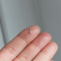 Please read before buying!  TEENY TINY CRYSTAL NOSE STUD * So tiny and sparkling  * L - shape post * Sold as single or pair  * Sterling silver - gold plated sterling silver  * Material stone: CRYSTAL - not real diamond  * Thickness post: 22 gauge/ 0.6mm (keep in mind that the post is thin and can be FLEXIBLE!) * Size crystal: 1.2mm or 1.7mm please note that size 1.2mm & 1.7mm are super tiny  ------------------*  More from us: https://nahnym.etsy.com * IG: @Nahnym_ ----------------- MATERIALS GOL Tiny Nose Piercing, Gold Nose Piercing, Diamond Nose Stud, Crystal Diamond, Nose Stud, Nose Piercing, Diamond Crystal, Diamond Sizes, Real Diamonds