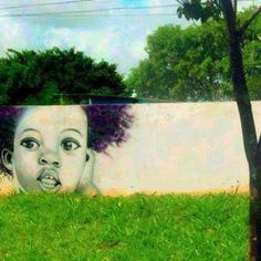 a painting of a child's face on the side of a building