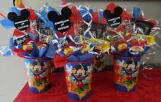 some mickey mouse cups with candy in them