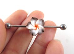 a person holding a flower shaped pin in their hand