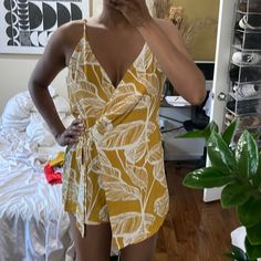 New With Tags And Out Of Stock! Beautiful Yellow Mustard Color With A White Floral Print. Back Zipper And Front Wrap. Size L On Tags But Can Also Fit A Size M. L’artiste Wrap Romper With Pockets. Yellow V-neck Jumpsuits And Rompers For Vacation, Yellow Summer Jumpsuits And Rompers For Vacation, Casual Yellow Printed Jumpsuits And Rompers, Yellow Summer Jumpsuits And Rompers For Loungewear, Chic Yellow Jumpsuits And Rompers For Day Out, Fitted Yellow Jumpsuits And Rompers For Brunch, Yellow Jumpsuit For Spring Day Out, Yellow Sleeveless Jumpsuits And Rompers For Loungewear, Yellow Sleeveless Jumpsuits For Loungewear