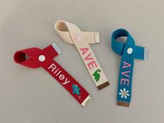 three pieces of fabric with the words ave riley on them and two pairs of scissors