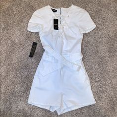 Bebe White Belted Lace Up Romper Size 00 Brand New With Tags White Fitted Jumpsuits And Rompers With Tie Waist, Fitted White Jumpsuits And Rompers With Tie Waist, White Fitted Jumpsuit With Tie Waist, Suede Jumpsuit, Tube Top Jumpsuit, Pink Corduroy Jacket, Black Tube Top, Jumpsuit Fitted, Satin Romper