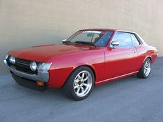 a red sports car parked in front of a building