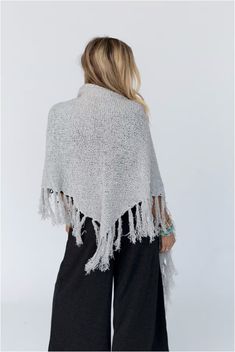 Drape yourself in the Moon Shadows Ruana Wrap and feel stylishly boho from day to night! This cozy-knit wrap features a loose and flowy silhouette, a beautiful triangular shape, and adorable tassel trim for a unique and versatile look. Infuse your wardrobe with some boho flair! Details: One size: 33 1/2"W x 86"L 100% Acrylic Hand wash cold, Lay flat to dry Import Ruana Wrap, Three Bird Nest, Moon Shadow, In The Moon, Knit Wrap, Beach Inspired, Cozy Knits, The Moon, Black And Grey