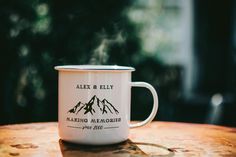 a white coffee cup sitting on top of a wooden table