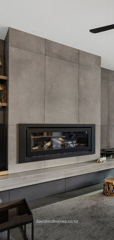 Sleek and modern concrete-look tiles frame this stunning minimalist fireplace, adding a refined industrial touch to the living room. The neutral tones and clean lines make it perfect for contemporary interiors, bringing warmth and sophistication to your home. Diy Concrete Look Fireplace, Concrete Tile Fireplace, Fireplace Ideas Modern Contemporary, Tiled Fireplace Wall, Fireplace Feature, Fireplace Tv Wall, Concrete Fireplace