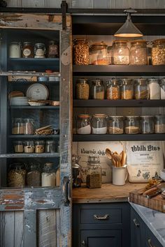 an old kitchen with lots of jars and other items on the shelves in front of it