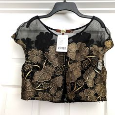 Brand Eva Franco Size Medium Black With Gold Embroidery Floral One Hook And Eye Jew With Tags Anthropologie 100% Polyester 100% Silk Contrast Dry Clean Only Crop Fit Black Embroidered Party Blouse, Black Festive Blouse For Spring, Fitted Black Embroidered Top For Fall, Festive Black Embroidered Top With Floral Details, Festive Black Embroidered Floral Top, Festive Black Tops With Intricate Embroidery, Festive Black Floral Embroidered Top, Black Top With Intricate Embroidery, Black Floral Embroidery Tops For Evening