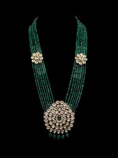 "Fariha Kundan Pendant Set - Emerald This wedding season you are looking outstanding when you wear this Antique finish long kundan big pendant set look like a Rani Haar. This neckless comes with matching earrings. A unique combination and design. This is a traditional look designer piece to add to your wardrobe. Perfect for the bride to pair it with any choker for a perfect look for reception or wedding function. This Kundan necklace set comes with antique Kundan finishing. That's the way it is Festive Green Kundan Mala, Green Fusion Kundan Necklace For Weddings, Green Temple Jewelry Mala For Festive Occasions, Green Fusion Style Jewelry For Diwali, Festive Green Mala For Celebrations, Green Fusion Bridal Necklace For Reception, Green Chandbali Bridal Necklace For Reception, Green Emerald Kundan Necklace With Gemstones, Green Gemstone Bridal Necklace In Temple Jewelry Style