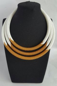 This is a 3 in 1 beaded necklace made using 100% original white and gold fine beads. The necklace comes with 2 matching bangles. It makes a perfect gift. Measurements; 20 inches(longest strand) 18 inches(middle strand) 16 inches(Shortest strand) The finishing is of gold color and S shape clasp is used for closure. **Buy multiple items and pay shipping for 1 item only.The rest ships free. More neckleces here; https://www.etsy.com/shop/TribalTess?ref=seller-platform-mcnav&section_id=21306083 B White Jewelry With Large Beads, White Polished Beaded Necklaces, White Beaded Necklaces With Polished Round Beads, White Polished Beaded Round Necklaces, White Beaded Necklaces With Large Beads, White Beaded Necklace With Large Round Beads, White Beaded Necklace With Large Beads, Traditional White Necklaces With Spacer Beads, Handmade White Beaded Round Necklace