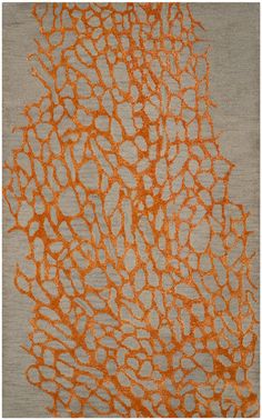 an orange and gray area rug with large circles on the center, in grey background