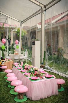 an outdoor party with pink and green decorations