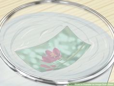 a glass plate with a pink flower on it