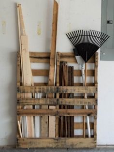 there is a wooden crate next to a fan on the floor in front of a white wall