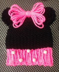 a crocheted minnie mouse hat with a pink bow on the front and black ears