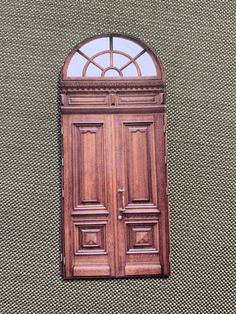 a wooden door with a glass window above it