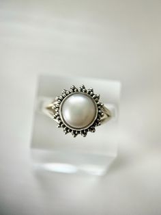 Embrace the carefree spirit of bohemian allure with our genuine freshwater pearl ring - a radiant expression of free-spirited elegance.  Pearls are timeless gems that never go out of style. They symbolize enduring beauty, elegance, and sophistication. Metal: 925 Sterling Silver Stone: Genuine round freshwater Pearl.  Stone size: 8 mm.  Ring size 12 mm.  Handcrafted in Thailand.  Receive a little extra joy with your order! 🎁 Natural gemstones are those formed by nature without human involvement Summer Wedding Jewelry With Pearl Charm, Summer Wedding Pearl Charm Jewelry, Bohemian Pearl Drop Jewelry For Summer, Summer Pearl Jewelry In Silver, Silver Pearl Jewelry For Summer, Elegant Silver Rings For Summer, Summer Silver Pearl Jewelry, Summer Pearl White Jewelry Gift, Classic Summer Jewelry For Gifts