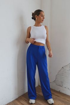 DETAILS: Our Lizzy High Waist Trousers In Blue have a high waisted fit and a wide legged fit. These bottoms have a waist pleated detail and two side pockets. The waistband has belt loops and for the closure there is a button, slide clasp, and zipper. CONTENT & CARE: SELF: 97% Polyester, 3% Spandex. SIZE & FIT: Model is 5'5" The model is wearing a size small. Fits true to size The Fabric has very little stretch Blue Pleated Pants Outfit, Bright Blue Pants Outfit, Cobalt Blue Pants Outfit, Blue Pants Outfit Ideas, Bright Blue Outfit, Royal Blue Pants Outfit, Electric Blue Pants, Blue Trousers Outfit, Pleated Pants Outfit